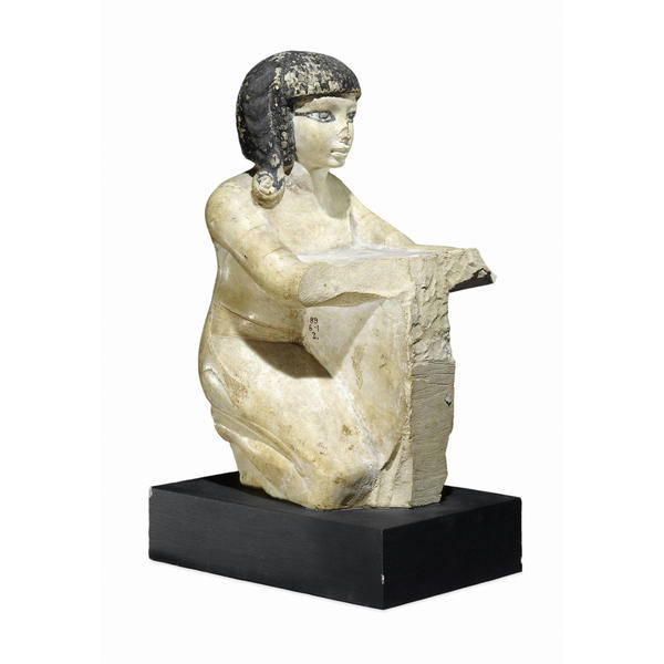 Limestone statuette of a priest holding an offering table