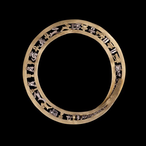 Gold bangle with gold and silver amulets